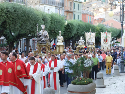 Le statue, seguite dai fedeli, attraversano piazza Fontana, la piazza centrale del paese